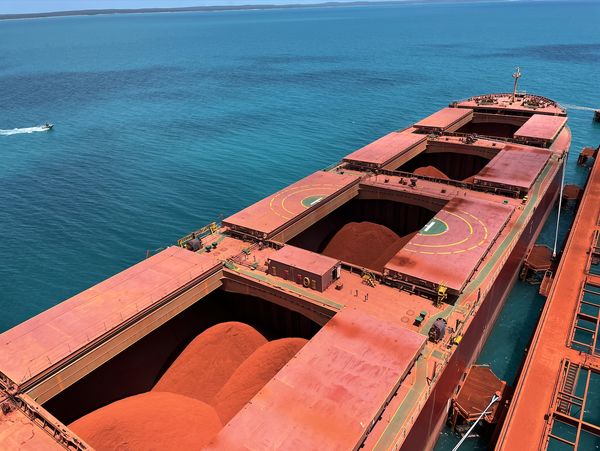 Aerial view of a loaded bulk carrier alongside a wharf